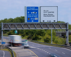 Truck and car driving fast on M50 in Dublin, Ireland